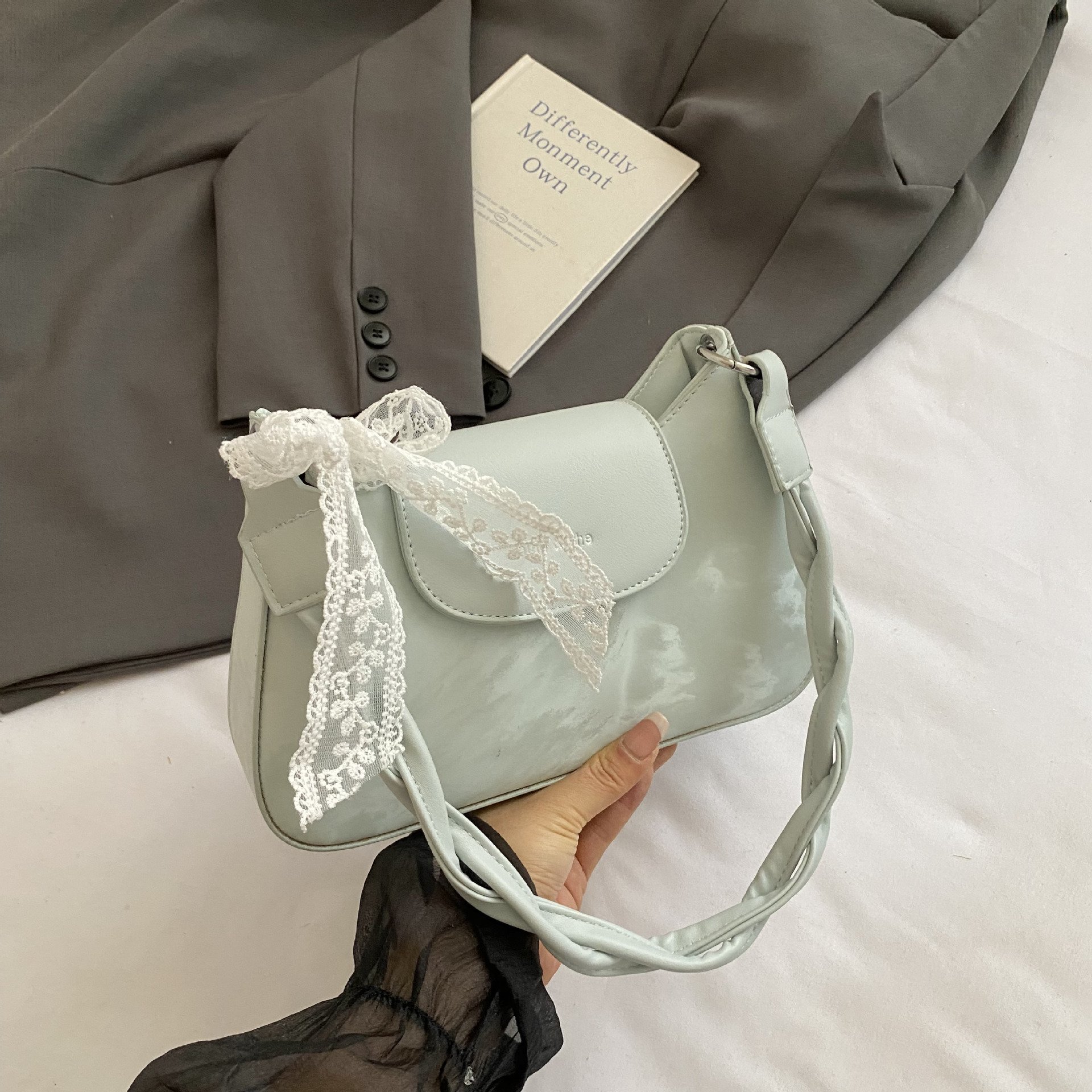 Twisted strap shoulder bag