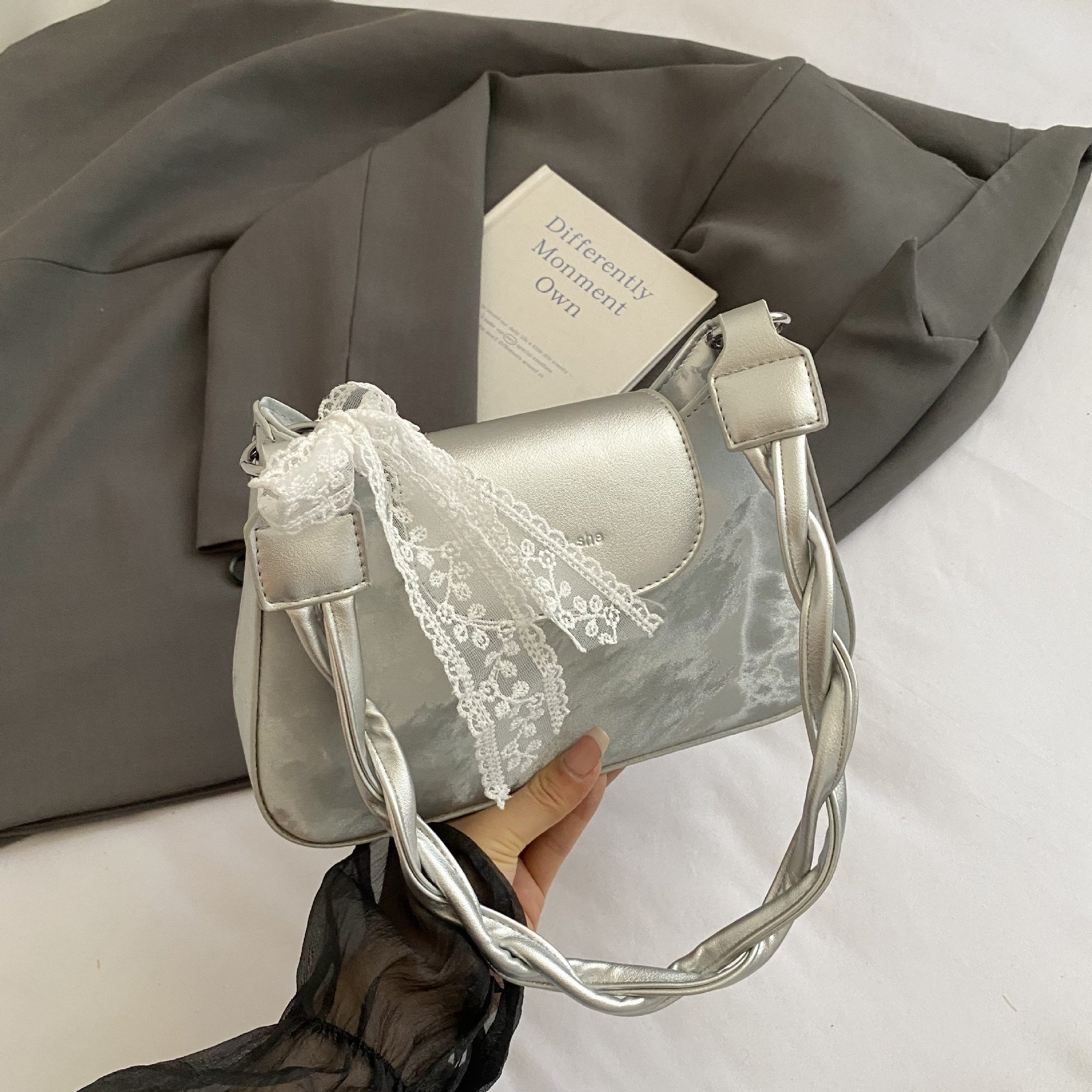 Twisted strap shoulder bag
